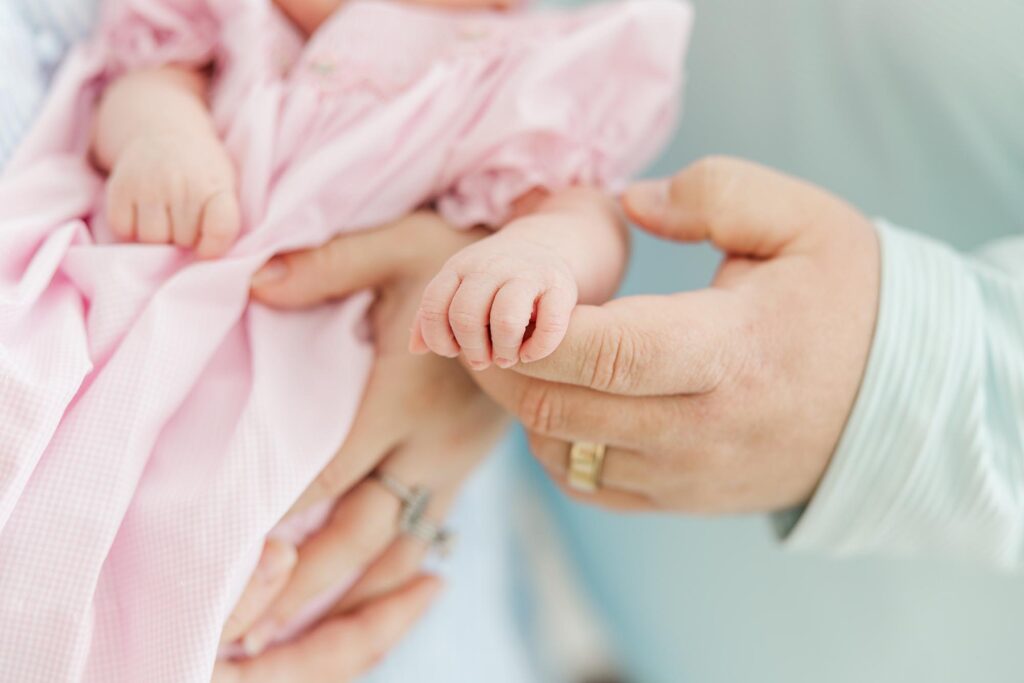 newborn had holding on to dads finger during apex newborn photography session