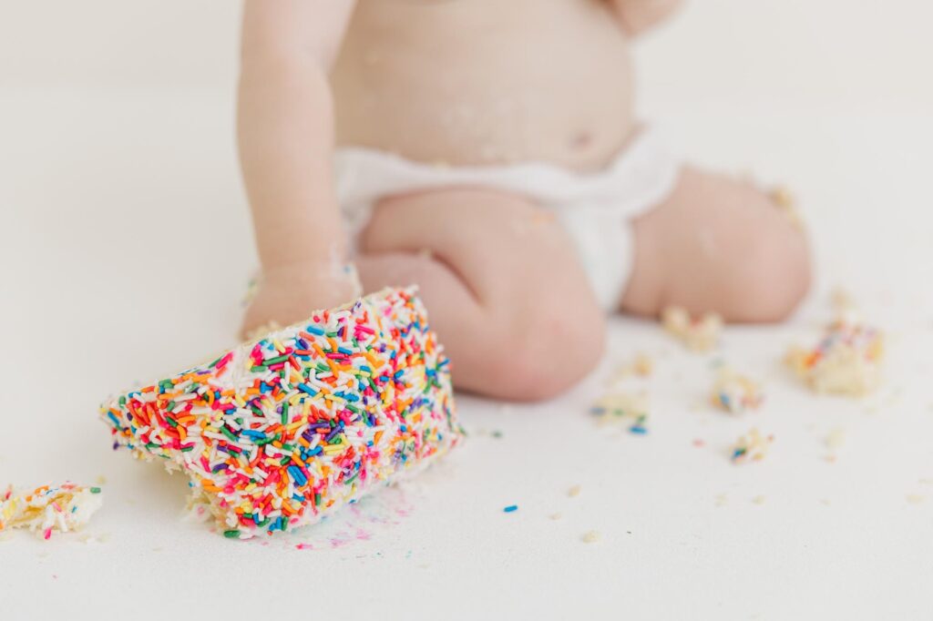 baby smashed white cake with multi colored sprinkles