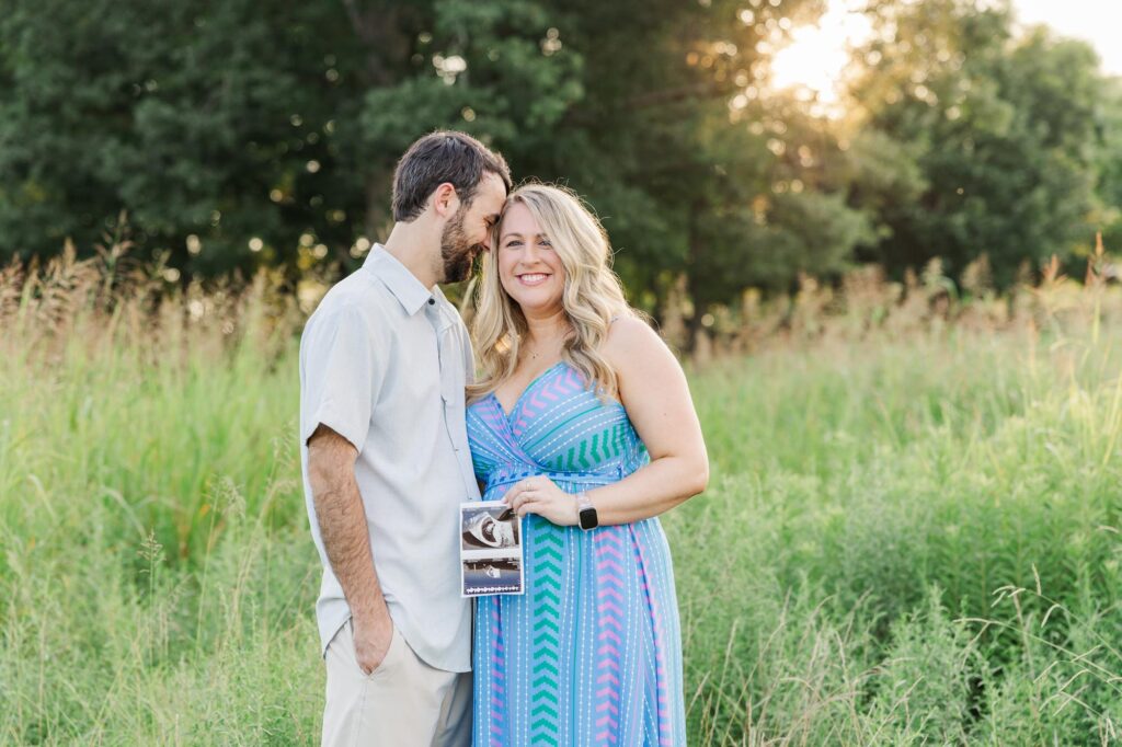 Couple holding ultra sound during their pregnancy announcement in a raleigh spring mini sessions