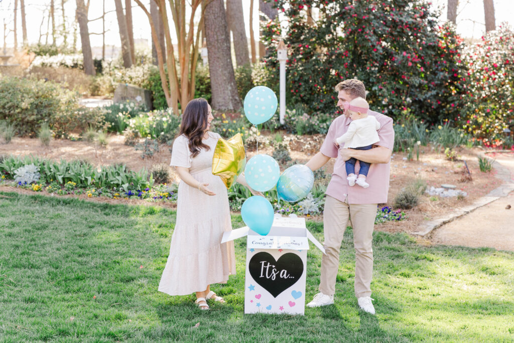 Family celebrating with balloons in a garden setting during a spring session at one of the most charming Raleigh photography locations.