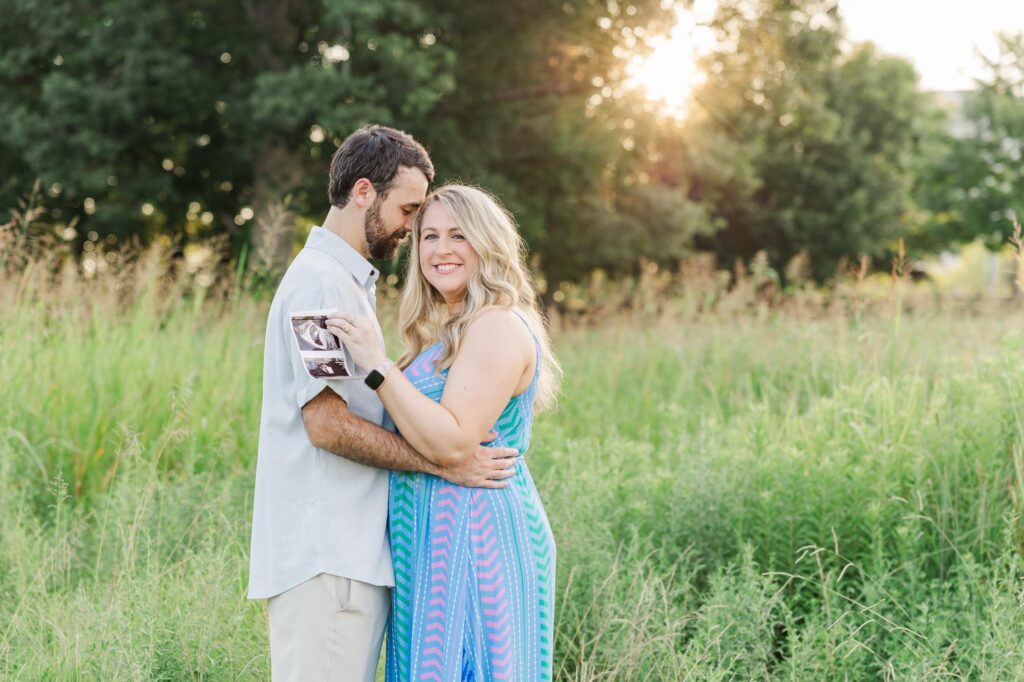 Couple embracing in golden sunset light at Historic Oak View County Park, one of the most scenic Raleigh photography locations.