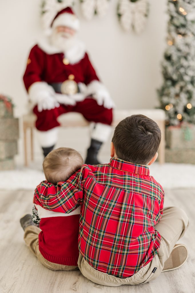 Two brothers sitting for their Santa photos in raleigh, NC 